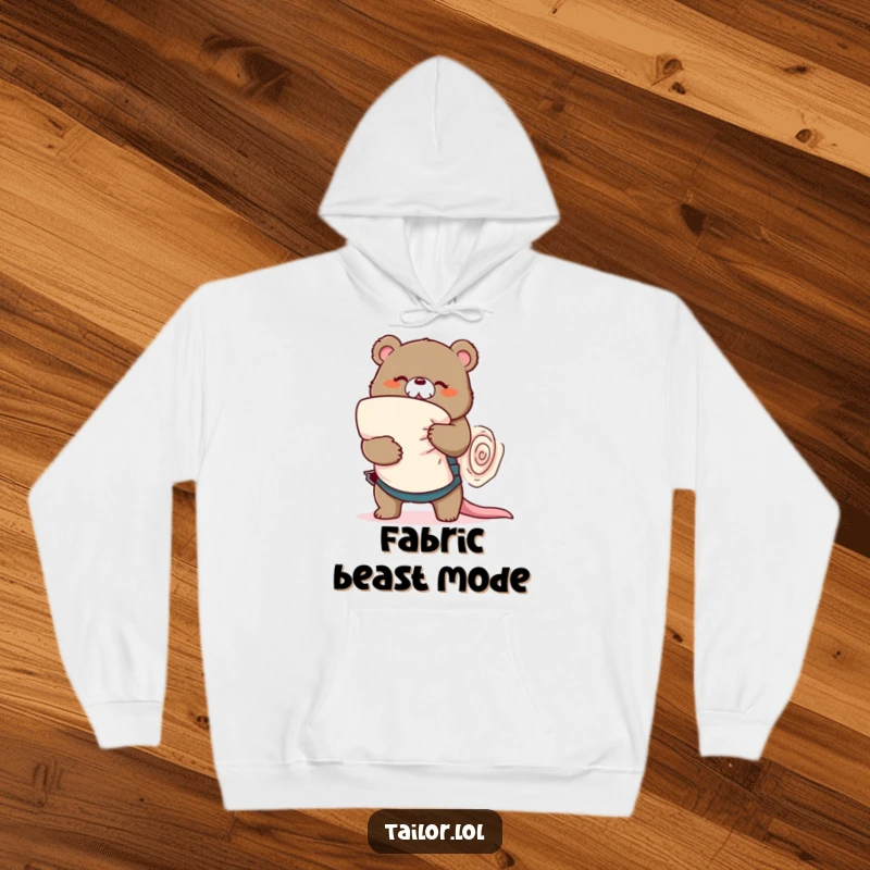 Funny playful bear tailor wrestling a large roll of fabric, cozy hoodie, sewing humor, perfect funny gift.